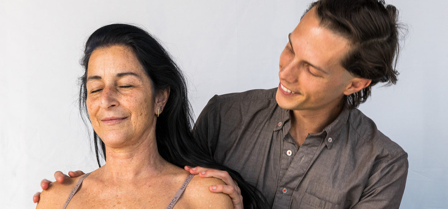 Matthew Doolin put hand shoulders of female patient, viewing woman from the right side