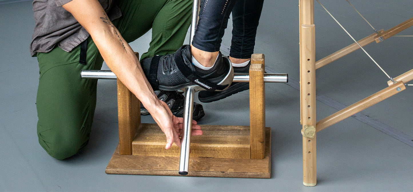 Matthew Doolin uses device to stretch out ankle during Active Isolated Stretching therapy